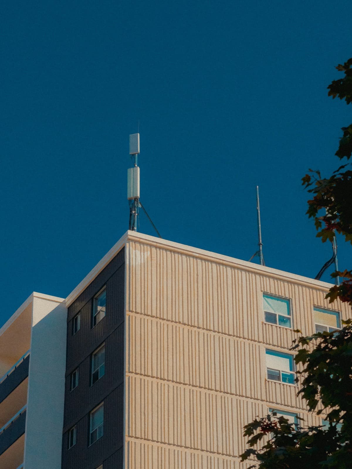Antennas on the roof of a building against a clear sky